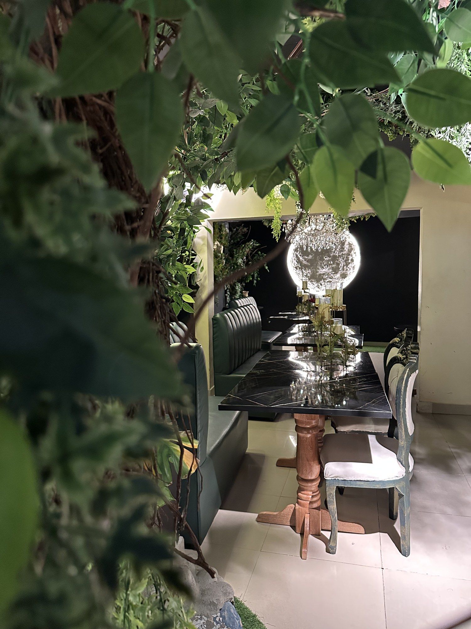 La mesa de la luna de Almonte Restobar: una lámpara redonda encendida vista entre ramas